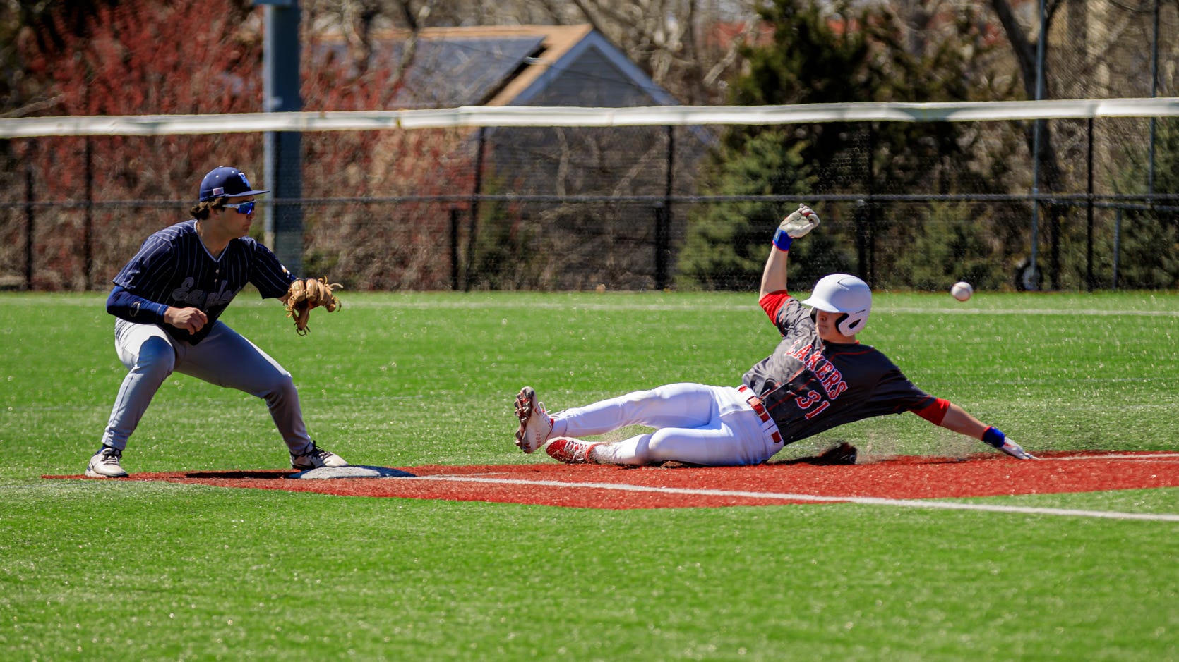 Anthony Miele slides into second base as Killian Murphy waits for the baseball to arrive.